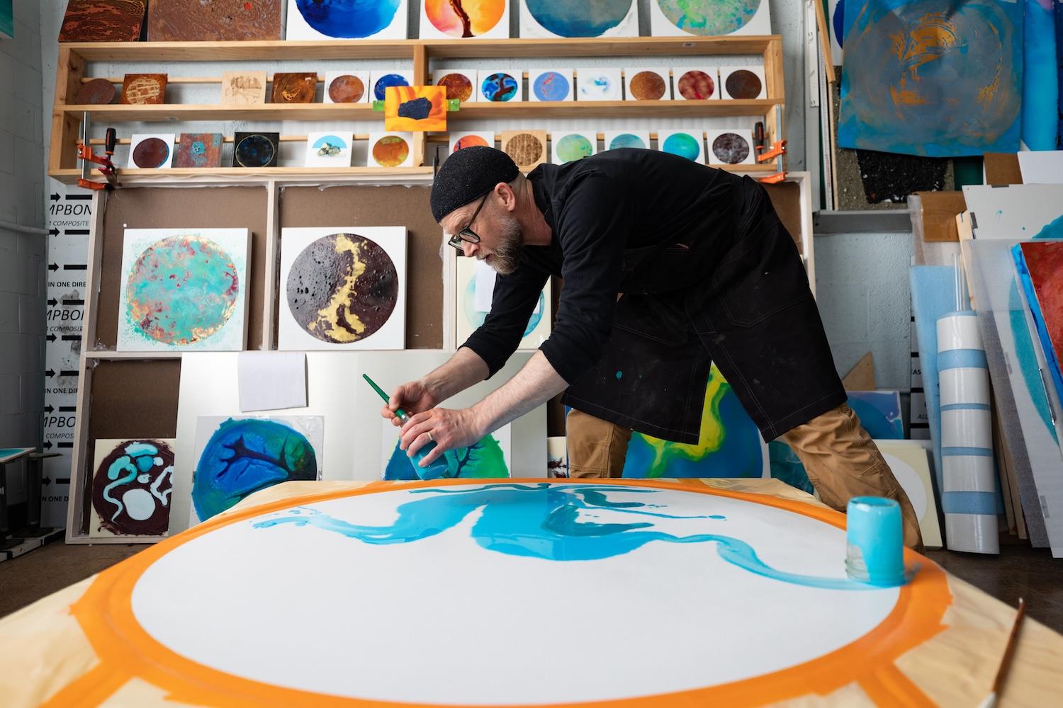 John Sabraw of Ohio University paints with pigment made from pollution in Sunday Creek